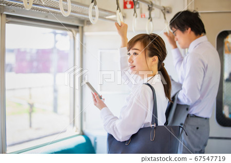 Woman looking at mobile on the train 67547719