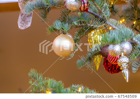Details of a Christmas tree with lovely ornaments Details of a Christmas tree with lovely ornaments 67548509