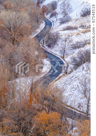 Curvy road on a snowy mountain in Salt Lake City Curvy road on a snowy mountain in Salt Lake City 67548519