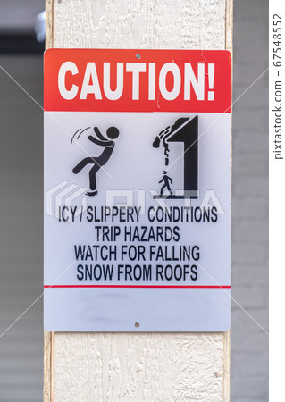 Caution sign on slippery and snowy area in winter Caution sign on slippery and snowy area in winter 67548552