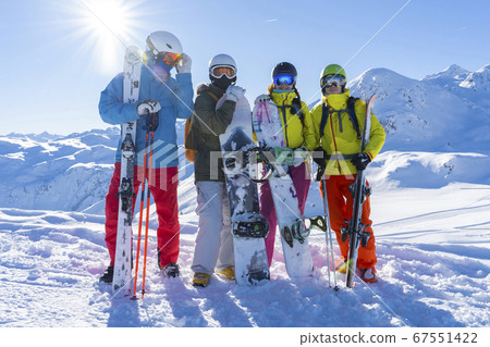 Four happy friends snowboarders and skiers are Four happy friends snowboarders and skiers are 67551422