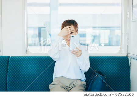 A woman riding a train 67552100