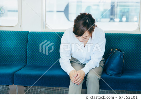 A woman riding a train 67552101