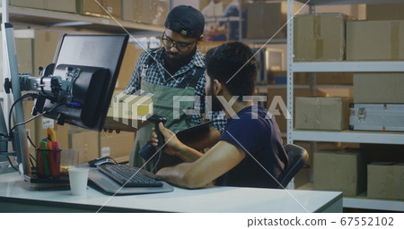 Young man working in distribution center 67552102