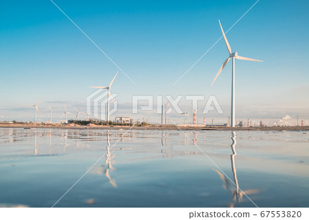 Windmill with sea reflection and wind power 67553820