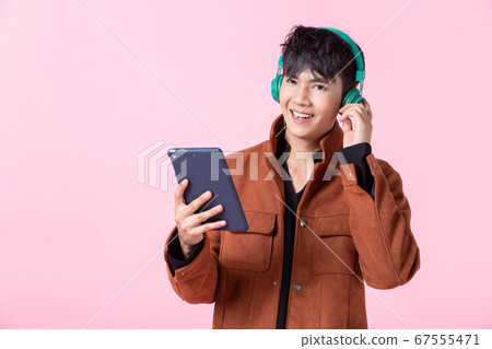 Asian a man handsome young in headphones is Asian a man handsome young in headphones is 67555471