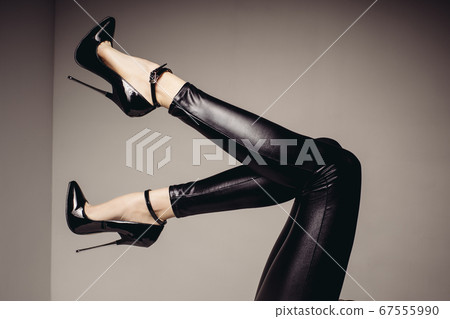 Slender female legs in spandex catsuit and a Slender female legs in spandex catsuit and a 67555990