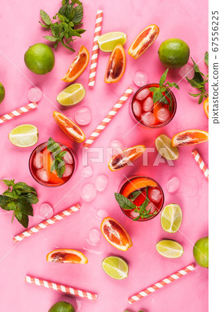 Summer pattern with citrus slices and red drink 67556225