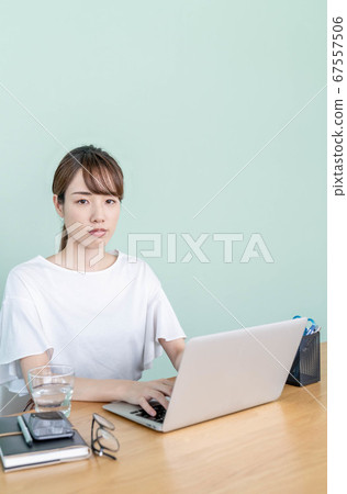 Young woman working remotely Young woman working remotely 67557506