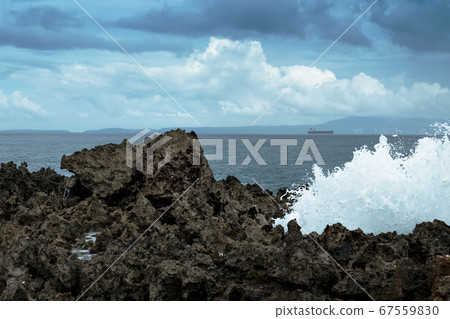 Waves break on rocky shore. Waves break on rocky shore. 67559830