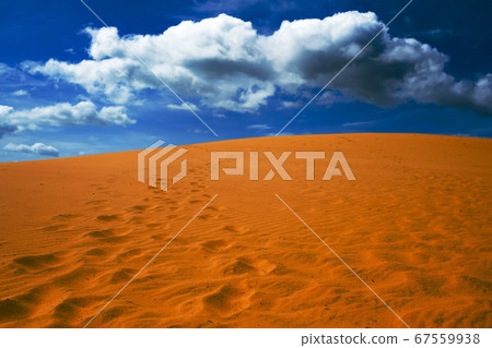 Bright yellow sand empties against the blue sky Bright yellow sand empties against the blue sky 67559938