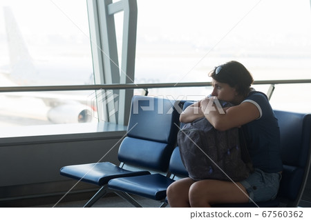 Tired caucasian woman in airport hall. Tired caucasian woman in airport hall. 67560362