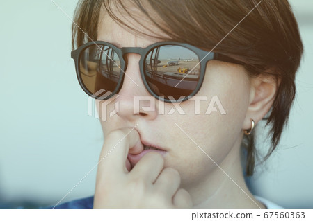 A woman is afraid to fly. A woman is afraid to fly. 67560363