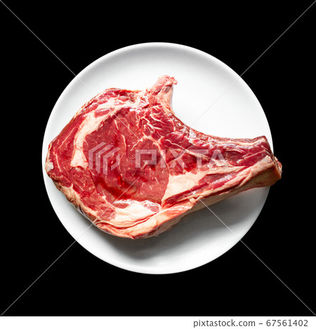 Beef prime rib on a plate isolated on black Beef prime rib on a plate isolated on black 67561402