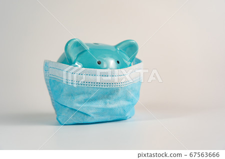 Ceramic piggybank wearing medical mask on white background 67563666