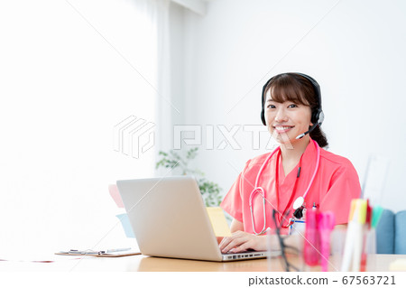 Smiling young female doctor with headphones doing online medical examination Smiling young female doctor with headphones doing online medical examination 67563721
