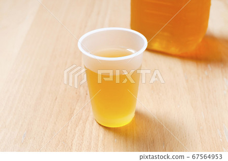 Tea in a plastic cup 67564953