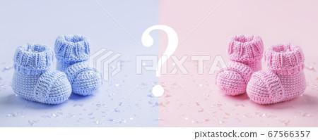 Pair of baby booties, shoes on the blue and pink Pair of baby booties, shoes on the blue and pink 67566357