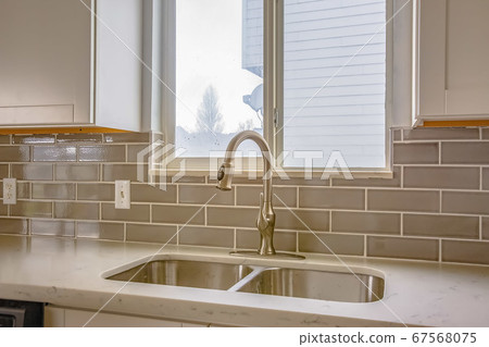 Double sink and faucet of a kitchen with view of Double sink and faucet of a kitchen with view of 67568075