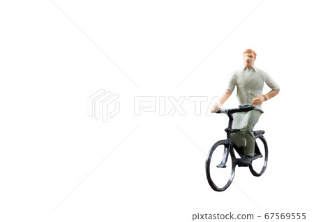 Miniature figure ride bicycle isolated on white background  67569555