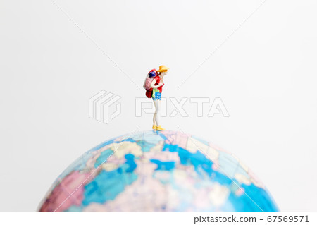 Miniature people figure standing on the globe Miniature people figure standing on the globe 67569571