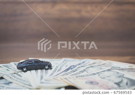 Car model on dollar banknotes  on wooden 67569583