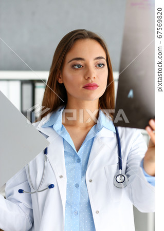 Beautiful female doctor hold in arm xray picture 67569820