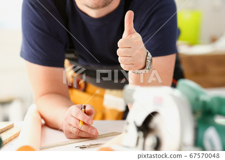 Arm of worker show confirm sign with thumb up Arm of worker show confirm sign with thumb up 67570048