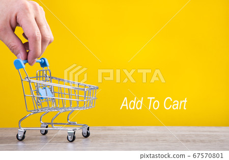 Hand with tiny shopping cart. Hand with tiny shopping cart. 67570801