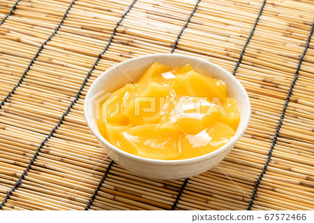 mango pudding. Summer image in the background blinds. 67572466