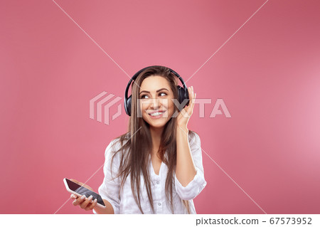 Beautiful woman listening to music using wireless Beautiful woman listening to music using wireless 67573952