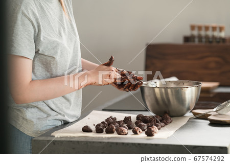 young woman making truffles candy on kitchen 67574292