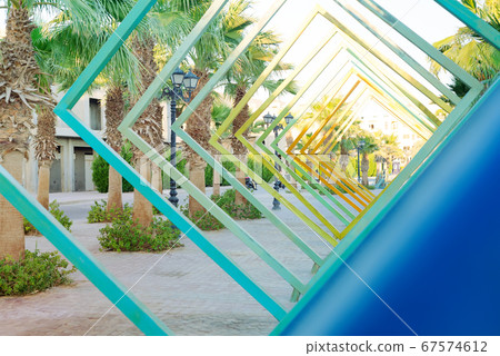 Abstract view of palm trees trough square perspective. 67574612