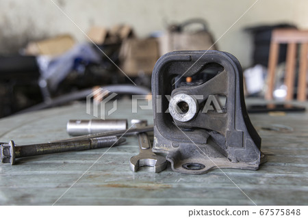 Old rubber engine mount with tools on the table 67575848
