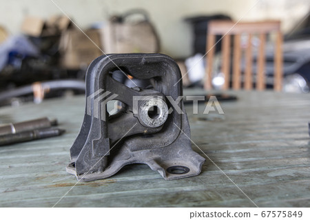Old rubber engine mount with tools on the table 67575849