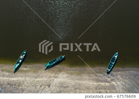 Fishing boats at the shore in the Volga River Delta. Aerial. 67576609