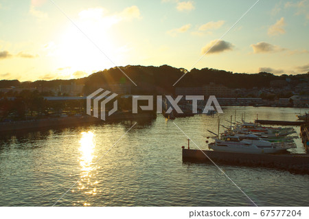 A beautiful sunset shines in the fishing port 67577204
