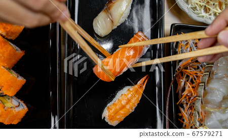 Hand holding chopstick for eat japan food Hand holding chopstick for eat japan food 67579271