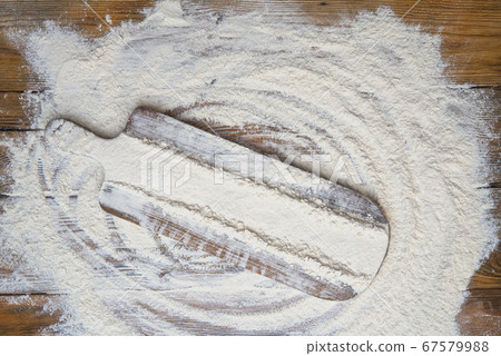White flour on old rustic wooden table, top view. White flour on old rustic wooden table, top view. 67579988