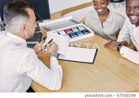 professional sales agent and clients have friendly conversation in dealership professional sales agent and clients have friendly conversation in dealership 67580299