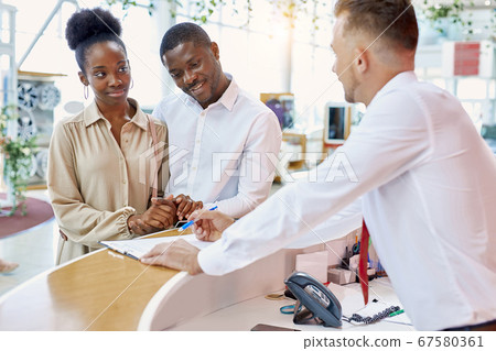 affable caucasian salesman show the document to customers 67580361