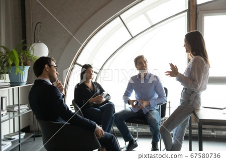 Motivated female leader head meeting with colleagues 67580736