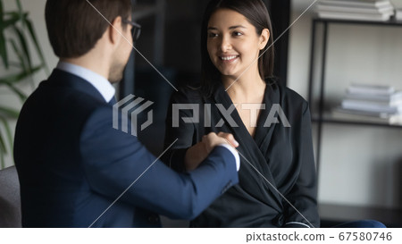 Smiling multiracial businesspeople handshake closing deal at meeting Smiling multiracial businesspeople handshake closing deal at meeting 67580746