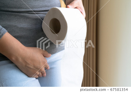 Disorder, Diarrhea, incontinence. Woman hand holding her crotch lower abdomen and tissue Disorder, Diarrhea, incontinence. Woman hand holding her crotch lower abdomen and tissue 67581354