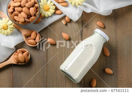 Bottle of fresh milk and Almonds nuts on wood Bottle of fresh milk and Almonds nuts on wood 67581511