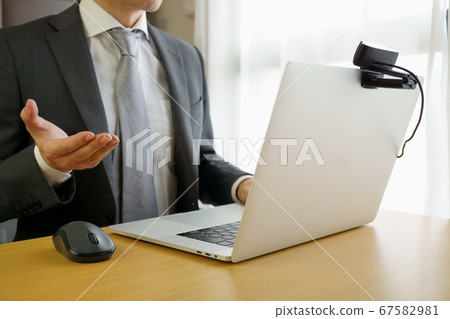 Man in a suit making a video call Man in a suit making a video call 67582981