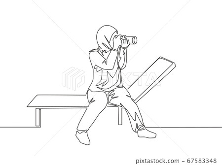 One continuous line drawing of young pretty happy muslimah with veil sitting on chair with camera One continuous line drawing of young pretty happy muslimah with veil sitting on chair with camera 67583348