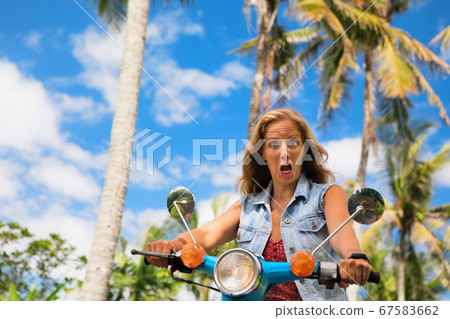 Strange girl riding on rental motorbike without Strange girl riding on rental motorbike without 67583662