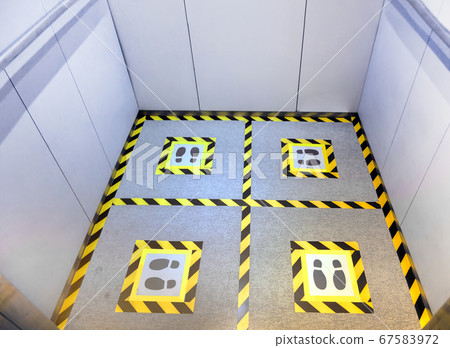 making social dostance on elevator floor with making social dostance on elevator floor with 67583972