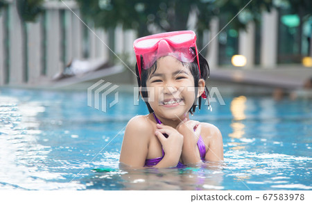 asian kid big smile to playing swim in water pool asian kid big smile to playing swim in water pool 67583978